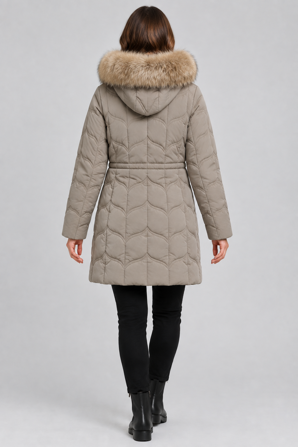 Back view of model wearing taupe quilted jacket with trimmed hood